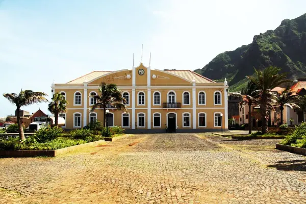 Yellow historic civic building and palm-lined square in Santo Antão