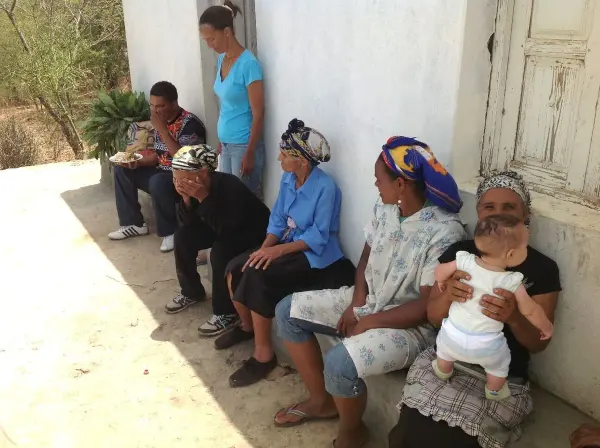 Residents gathered outside a house in Fogo